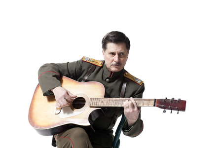russian officer playing guitar isolated on whiteの写真素材