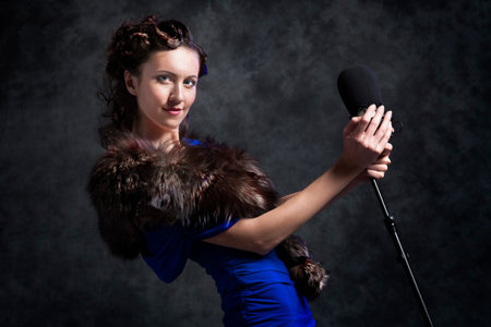 beautiful woman with microphone in dusk