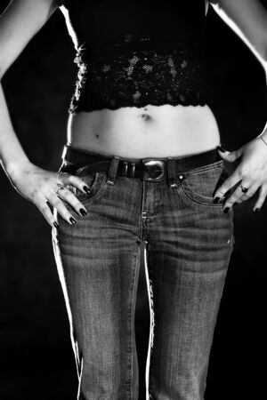 lower body part of slender woman in jeans in black and white colorsの写真素材