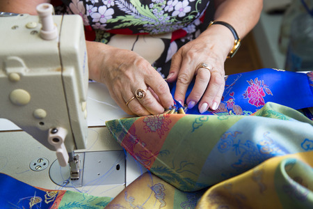 close-up of woman working at the sewing machineの写真素材