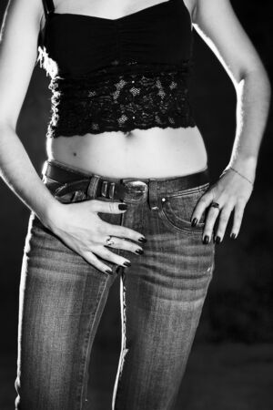 lower body part of slender woman in jeans in black and white colorsの写真素材
