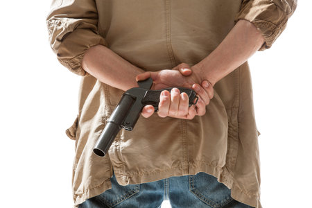 Man hiding gun behind his back