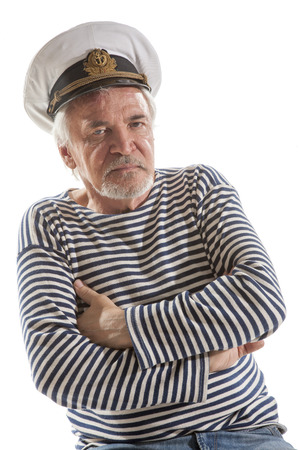 Portrait of old sailor man in striped shirt and hat isolated on white backgroundの写真素材