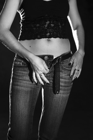 sexy woman unzipping her jeansの写真素材