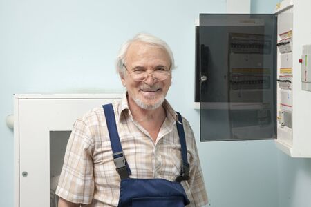 Elder man getting ready to fix an electric meterの写真素材