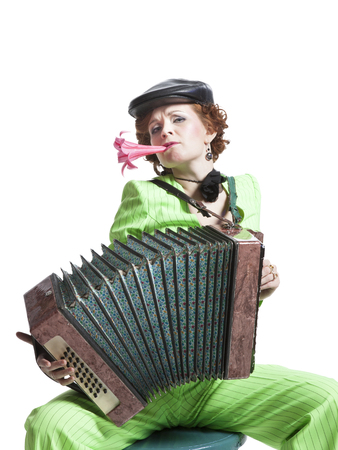 Pretty woman in Retro style costume playing accordionの写真素材