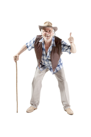 Full length portrait of a senior man walking with cane  giving thumbs up isolated on white backgroundの写真素材