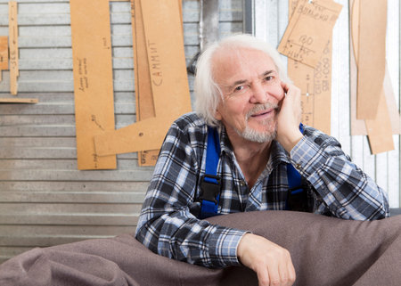 Worker using saw machine to make furniture at carpenters workshop. Handmade business at small furniture factory.の写真素材
