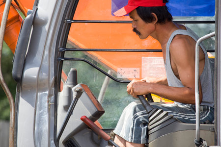 The driver-excavator driver in the cabin controls the process of moving the ground.Driver -...