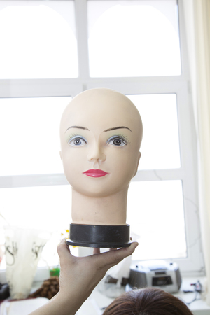 Bald head of a mannequin with blue eyes without a wigの写真素材