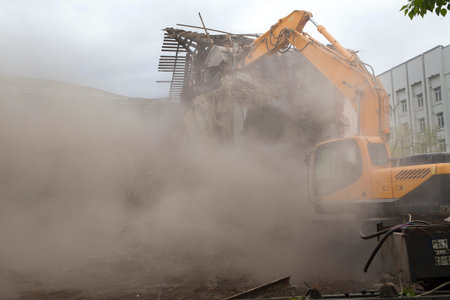 The destruction of the walls of the old building and the cleaning of construction debris with a...