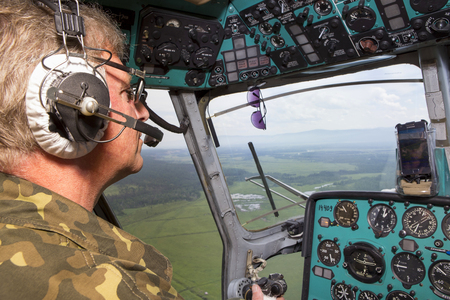 Russia, the Republic of Buryatia, the village of Kiren, flight by helicopter MI 2 - July 01, 1917:
Takeoff, flight and landing of the helicopter. View from the cockpit. Dashboard. The pilot controls the helicopter.のeditorial素材