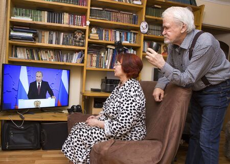 ULAN - UDE, RUSSIA - February 20, 2019: a married couple of Russian pensioners at home are watching on TV the annual message of Russian President Vladimir Putin to the Russian parliamentのeditorial素材