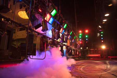 Light effects on stage created with theatrical lighting equipment and a smoke machine
