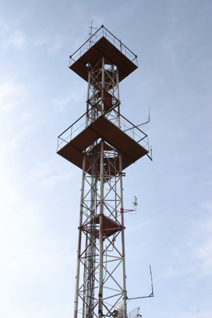Tower of radio, telecommunications, cellular telephony on a background of blue sky