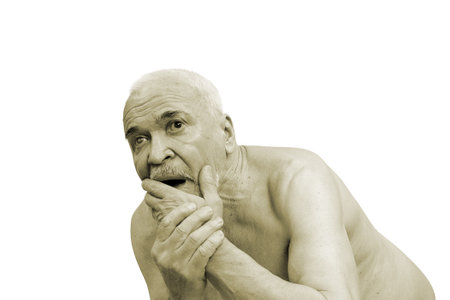 An elderly man, naked to the waist, screams and shakes with shock and horror. Isolated on white.の写真素材