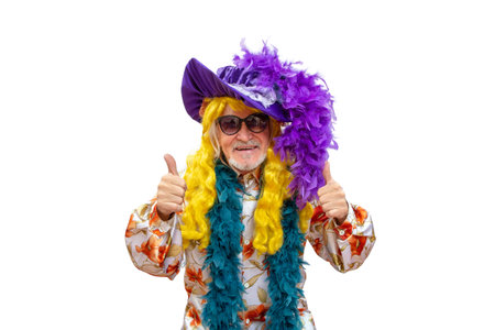 Cheerful happy man in bright clothes and a wig showing thumbs up, celebrating his luck and showing his happinessの写真素材