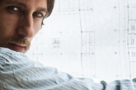 young male student in architecture has unfolded a projectの写真素材