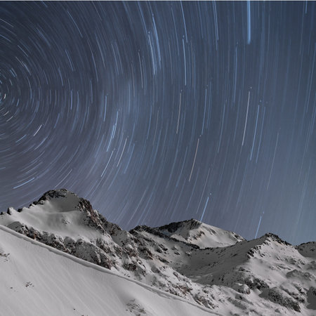 Winter landscape  Star trails, snow capped mountains, long exposure
