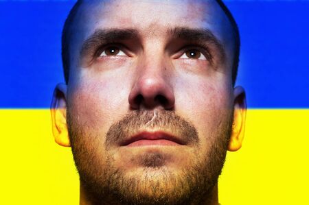 Portrait of a man at the flag of Ukraineの写真素材