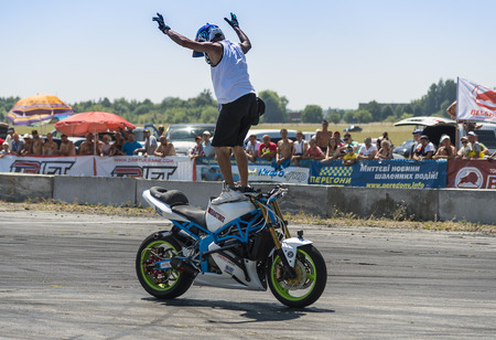 Vinnytsia,Ukraine-July 25, 2015: Unknown stunt biker entertain the audience before the start of the championship of drifting   on July 25,2015 in Vinnytsia, Ukraine.のeditorial素材