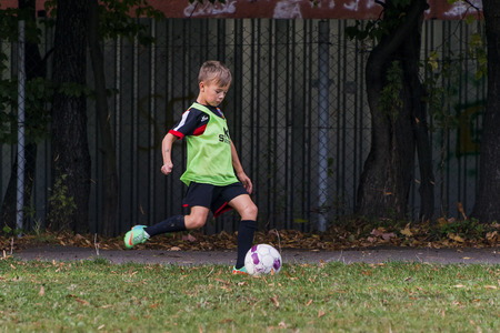 Lviv, Ukraine - 30 Septemberl 2016: Boy hits the ball during a game of footballl on the playground near the school Lviv.のeditorial素材
