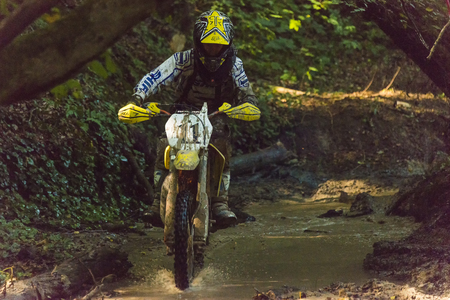 Lviv, Ukraine - 11 Septemberl 2016: The third stage of the Ukrainian championship in cross-country cycling . Unknown  racer overcomes the track in the forestのeditorial素材