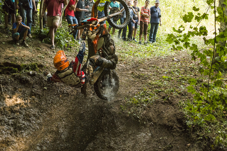Lviv, Ukraine - 11 Septemberl 2016: The third stage of the Ukrainian championship in cross-country cycling . Unknown rider falls at overcoming the track in the woodsのeditorial素材