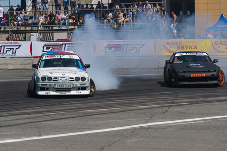 Lviv, Ukraine - Juny 7, 2015: Unknown riders on the car brand Nissan and BMW overcomes the track in the championship of Ukraine drifting in Lviv.のeditorial素材