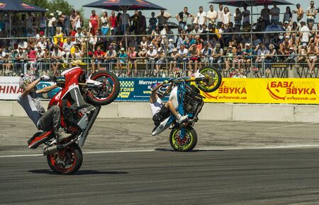 lLviv, Ukraine - June 7, 2015: Unknown stunt bikers  entertain the audience before the start of the championship of drifting near Arena - Lviv stadium in Lviv, Ukraine.のeditorial素材