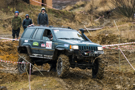 Lviv, Ukraine - February 21, 2016: Off-road vehicle brand Jeep Cherokee overcomes the track on a amateur competitions Trial near the city Lviv, Ukraineのeditorial素材