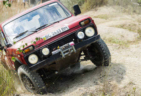 Lviv, Ukraine - August 23, 2015: Off-road vehicle brand VAZ- NIVA overcomes the track on of sandy career near the city Lviv, Ukraine.のeditorial素材