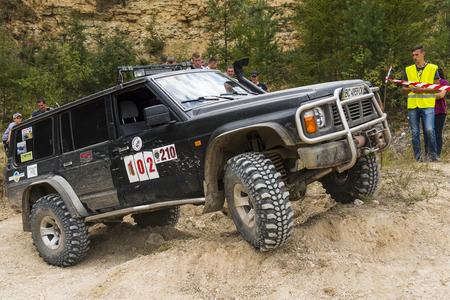 Lviv, Ukraine - August 23, 2015: Off-road vehicle brand Nissan overcomes the track on of sandy career near the city Lviv, Ukraine.のeditorial素材