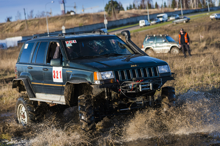 Lviv,Ukraine- December 6, 2015: Tuned off-road vehicle brand Jeep Cherokee overcomes the track on a polygon near the city Lviv, Ukraine.のeditorial素材