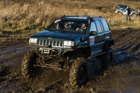 Lviv,Ukraine- December 6, 2015: Off-road vehicle brand Jeep Cherokee overcomes the track on a polygon near the city Lviv, Ukraine.のeditorial素材