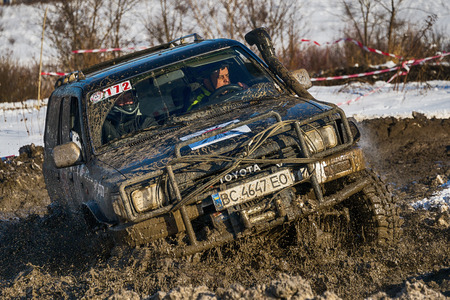 Lviv, Ukraine - December 04, 2016: Unknown racers  on off-road vehicle Nissan overcomes the track at amateur competitions among off-road vehicles near ringroad of  the city Lviv, Ukraineのeditorial素材