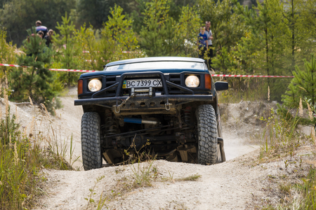 Lviv, Ukraine - August 23, 2015: Off-road vehicle brand Land Rover overcomes the track on of sandy career near the city Lviv, Ukraine.のeditorial素材