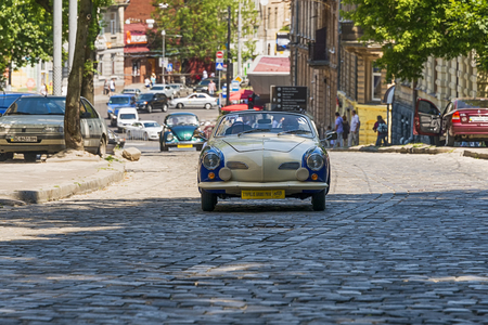 Lviv, Ukraine - June 4, 2017: Old retro car Volkswagen Karmann Chia with its owner and au unknown passenger taking participation in race Leopolis grand prix 2017, Ukraine.のeditorial素材