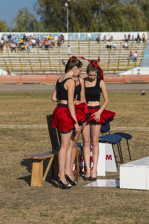 Rivne, Ukraine - 29 August 2015: Pit lane girls getting ready for a competition on the Open Cup Speedway to the day of the city Rivneのeditorial素材