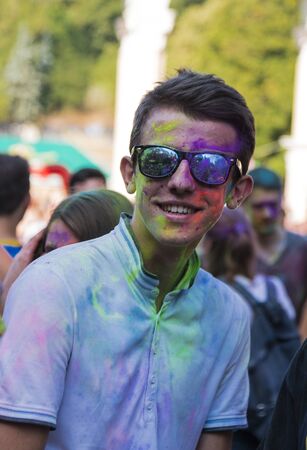 Lviv, Ukraine - August 30, 2015: Man with glases have fun during the festival of color in a city park in Lviv.のeditorial素材