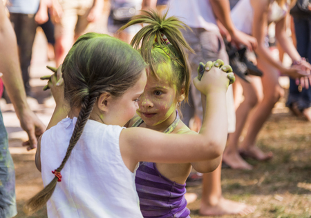 Lviv, Ukraine - August 30, 2015: Little girls dance during the festival of color in a city park in Lviv.のeditorial素材