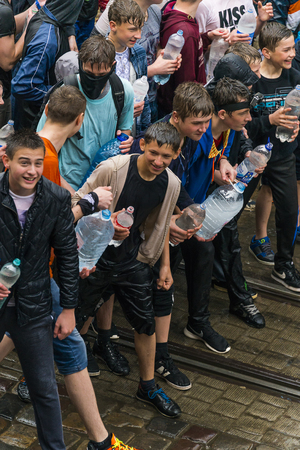 Lviv, Ukraine - May 2,  2016: Celebration pouring water on Monday after Easter by the town hall. Guys are ready to spray water on each other.のeditorial素材