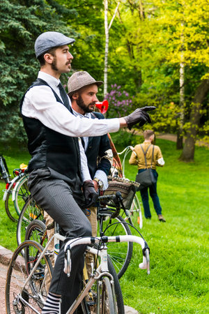 Lviv, Ukraine - May 7, 2016; Unknown  participant  of retro Bike rally  indicates the starting place  in the city park in Lviv.のeditorial素材