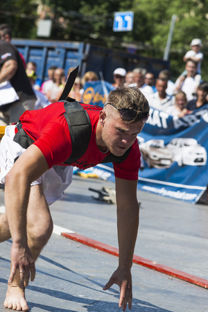 Lviv, Ukraine - July 05, 2015: Strongman pulls Toyota Highlander in Yarych street Fest 2015  near centrum  of  Lviv  city.のeditorial素材