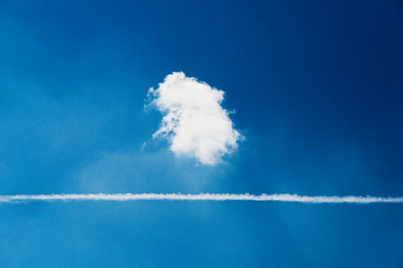 white cloud and condensation trace in the sky
