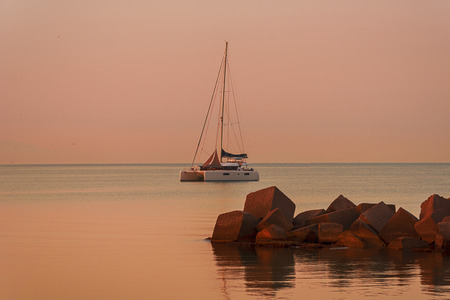 Yacht - catamaran in the evening bayの写真素材