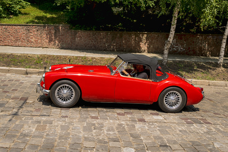 Lviv, Ukraine - June 3, 2018:Old retro car MGA 1500 with its owner and an unknown passenger taking participation in race Leopolis grand prix 2018, Ukraine.のeditorial素材