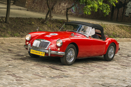 Lviv, Ukraine - June 3, 2018:Old retro car MGA 1500 with its owner and an unknown passenger taking participation in race Leopolis grand prix 2018, Ukraine.のeditorial素材