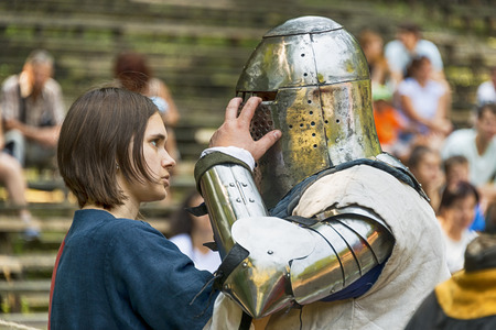 Lviv , Ukraine â august , 04, 2018:  Festival of medieval history and knight duels, the lady helps the knight wear armor in the city park of the city of Lviv.のeditorial素材