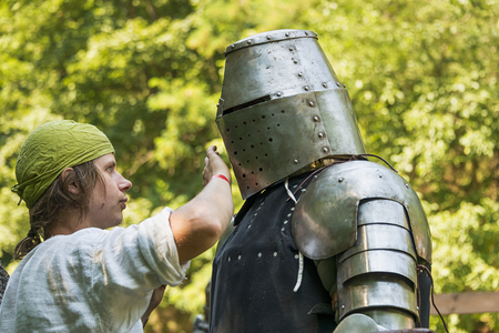 Lviv , Ukraine â august , 04, 2018:  Festival of medieval history and knight duels. Participants of the festival wear armor before the start of fights in the city park of the city of Lviv.のeditorial素材